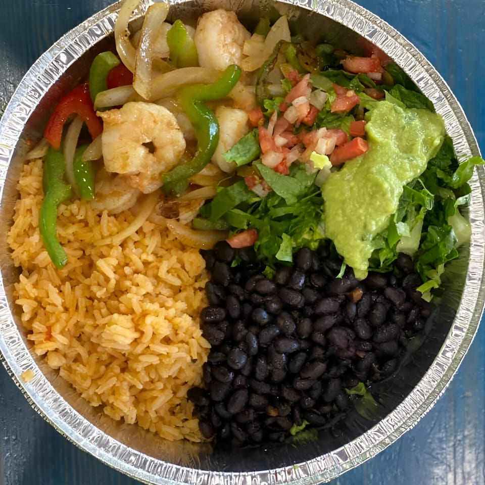 Shrimp fajita bowl from Oscar's Taco Shop with rice, black beans, and guacamole.